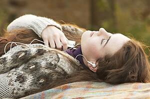 Portrait Of Beautiful Teenage Girl Outdoors Listening To MP3 Player In Autumn Landscape