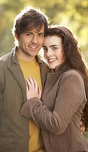 Portrait Of Romantic Young Couple In Autumn Landscape