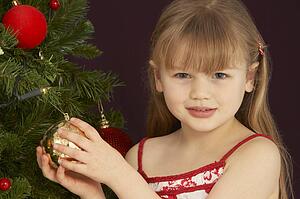 Young Girl Decorating Christmas Tree