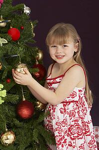Young Girl Decorating Christmas Tree