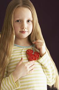 Young Holding Heart Shaped Cookie In Studio