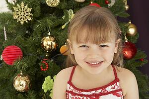 Young Girl Decorating Christmas Tree