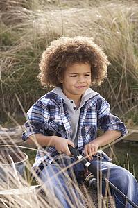 Young Boy Fishing At Seaside