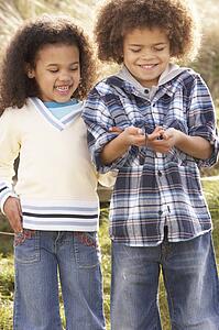 Children Holding Worm Outdoors