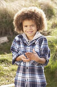Young Boy Holding Worm Outdoors