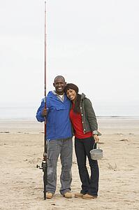 Couple Fishing On Beach