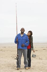 Couple Fishing On Beach