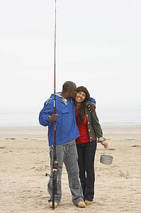 Couple Fishing On Beach