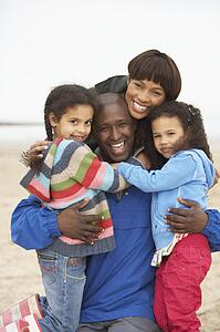 Family Relaxing On Winter Beach Break 