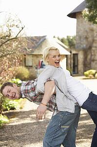 Portrait Of Energetic Young Couple Having Fun