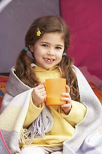 Young Girl Relaxing Inside Tent On Camping Holiday