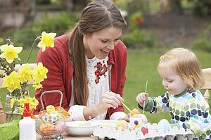 Mother And Daughter Painting Easter Eggs In Gardens