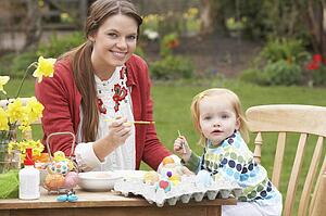 Mother And Daughter Painting Easter Eggs In Gardens