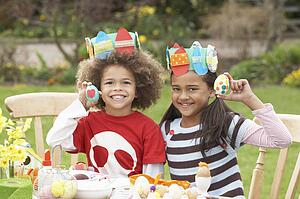 Children Painting Easter Eggs In Gardens