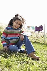 Young Girl Sitting Outside In Caravan Park
