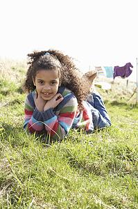 Young Girl Sitting Outside In Caravan Park