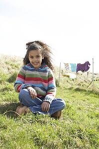 Young Girl Sitting Outside In Caravan Park