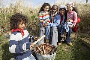 Family Having Barbeque On Winter Beach