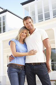 Young Couple Standing Outside Dream Home