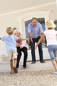 Grandparents Welcoming Grandchildren On Visit To Home