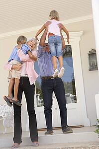 Grandparents Welcoming Grandchildren On Visit To Home