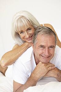 Senior Couple Relaxing On Bed