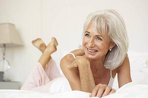 Senior Woman Relaxing On Bed