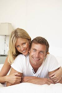 Young Couple Relaxing On Bed