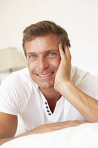 Young Man Relaxing On Bed