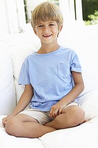 Portrait Of Young Boy Relaxing On Sofa
