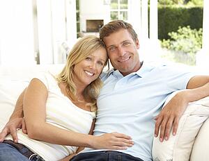 Portrait Of Young Couple Relaxing Together On Sofa