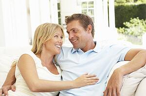 Portrait Of Young Couple Relaxing Together On Sofa