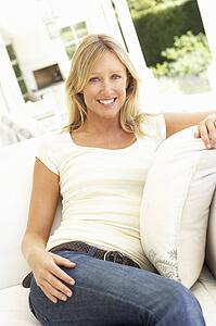 Portrait Of Young Woman Relaxing On Sofa