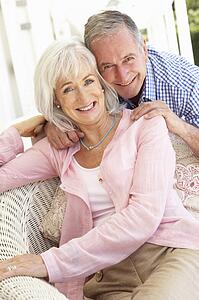 Portrait Of Senior Couple Relaxing Together On Sofa