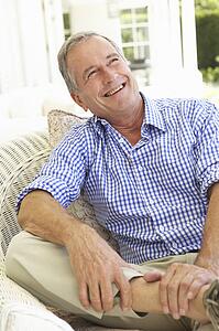 Portrait Of Senior Man Relaxing In Chair