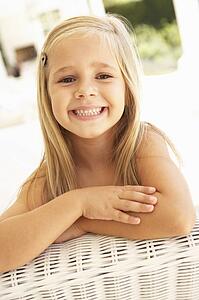 Portrait Of Young Girl Relaxing On Sofa