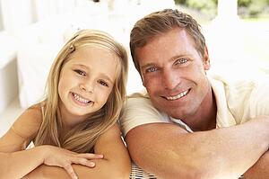 Portrait Of Mother And Daughter Relaxing Together On Sofa