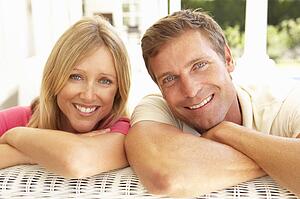 Portrait Of Young Couple Relaxing Together On Sofa