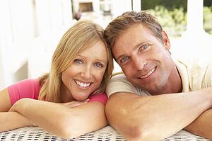 Portrait Of Young Couple Relaxing Together On Sofa