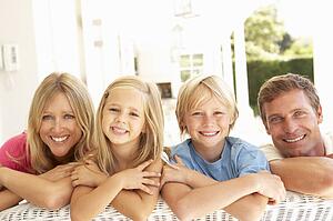 Portrait Of Young Family Relaxing Together On Sofa