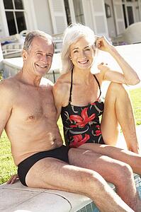 Senior Couple Relaxing by Outdoor Pool