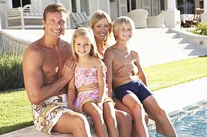 Family Outside Relaxing By Swimming Pool
