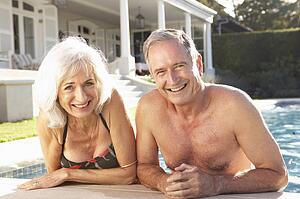Senior Couple Relaxing by Outdoor Pool