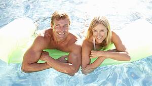 Couple Outside Relaxing In Swimming Pool