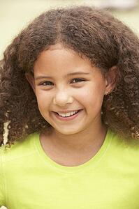 Portrait Of Happy Young Girl In Park