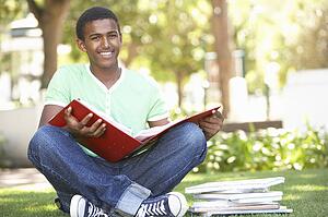 Male Teenage Student Studying In Park