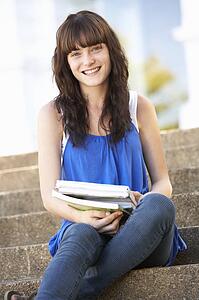 Teenage Student Sitting Outside On College Steps