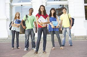 Group Of Teenage Students Standing Outside College Building