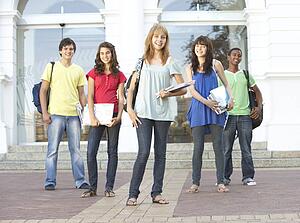 Group Of Teenage Students Standing Outside College Building