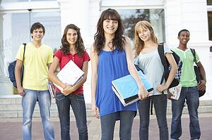 Group Of Teenage Students Standing Outside College Building